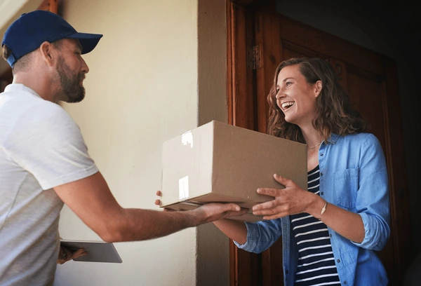A delivery person handing over a cake box